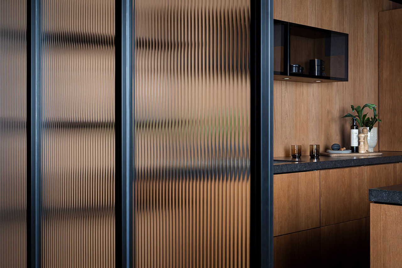 Gallery i svart profil og glassvegg med linjeglass